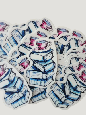 Stack of books with teacups on top, arranged in a circular pattern on a white background.