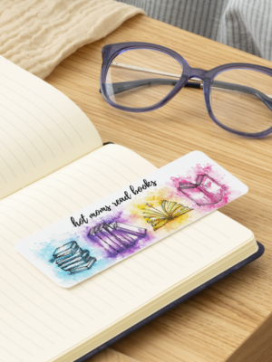 Book with a colorful bookmark featuring butterflies on a wooden table.