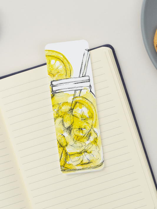 Notebook with a water bottle illustration featuring lemons on a light surface.
