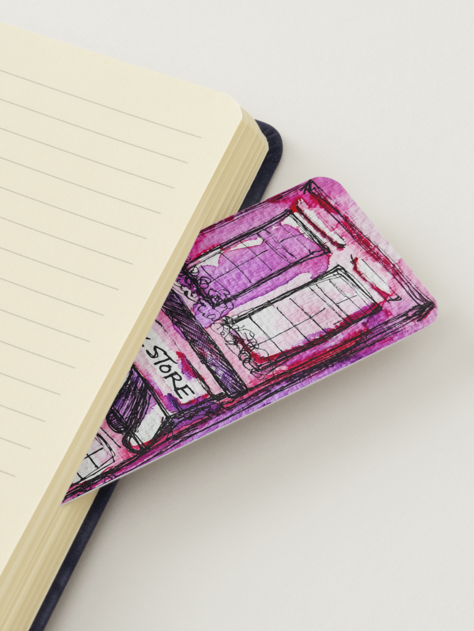 Notebook with a pink store drawing on a bookmark peeking out