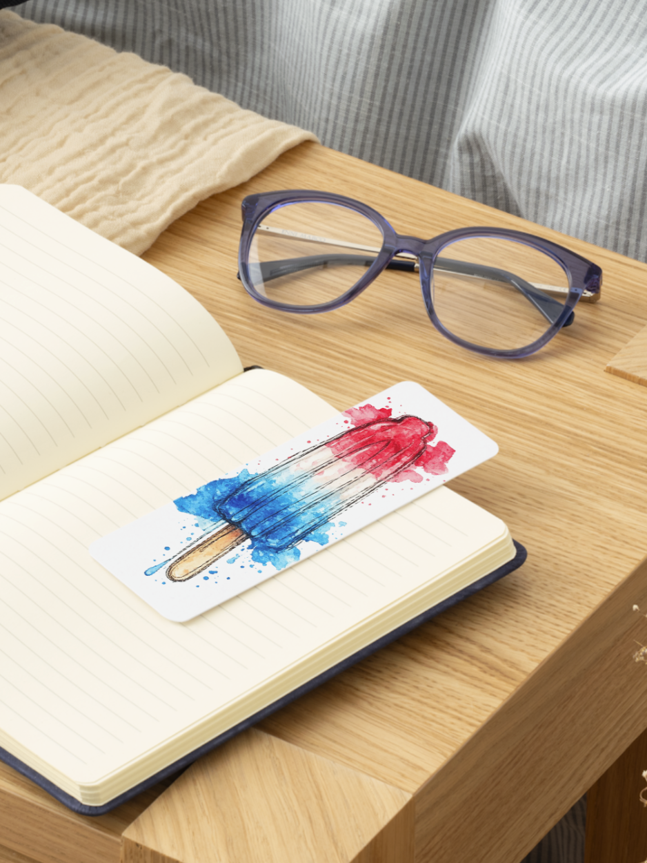 Red white and blue Bomb Pop watercolor bookmark inspired by classic popsicles, featuring hand-painted artwork and printed on textured cardstock for summer reading and patriotic gifts.